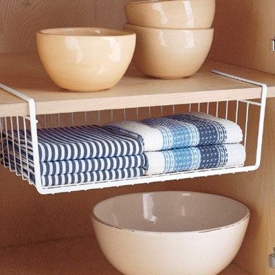 kitchen towel storage (container store) Kitchen Towels Storage, Under Shelf Storage, Under Shelf Basket, Kitchen Rails, Shelf Baskets Storage, Lid Storage, Towel Storage, Kitchen Cabinet Organization, Cabinet Space