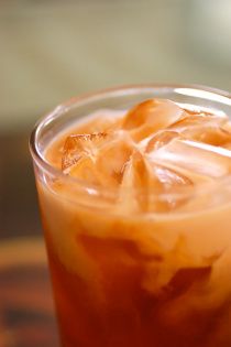 ~Thai Iced Tea~ Bring 6c of water, 1/2c sugar, 5 star anise, 2 cinnamon sticks, 1/4 tsp ground tamarind to a boil. Take off heat, let 8 bags black tea (or 6bags black tea & 2 bags rooibos) steep for 1 hour at room temp. Tea should be very strong, it gets diluted. Remove bags, anise & sticks. Whisk in 1/2c sweetened condensed milk and vanilla to taste. Refrigerate. Fill glass with ice & 3/4 full with tea. Top off with coconut milk, don't stir. Add chocolate mint as garnish. Thai Tea Recipe, Tai Tea, Thai Iced Tea Recipe, Thai Tea Recipes, Thai Iced Tea, Iced Tea Recipe, Tasty Thai, Thai Tea, Tea Recipe