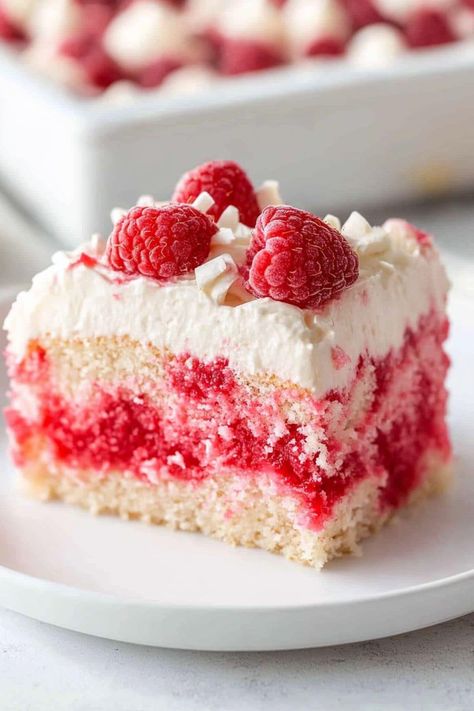 This white chocolate raspberry poke cake is such a stunner! It's light, easy to make, and such a refreshing treat. White Chocolate Raspberry Poke Cake, Chocolate Raspberry Poke Cake, Berry Poke Cake, Raspberry Poke Cake, White Chocolate Raspberry Cake, Raspberry Pie Filling, White Chocolate Frosting, White Chocolate Shavings, White Raspberry