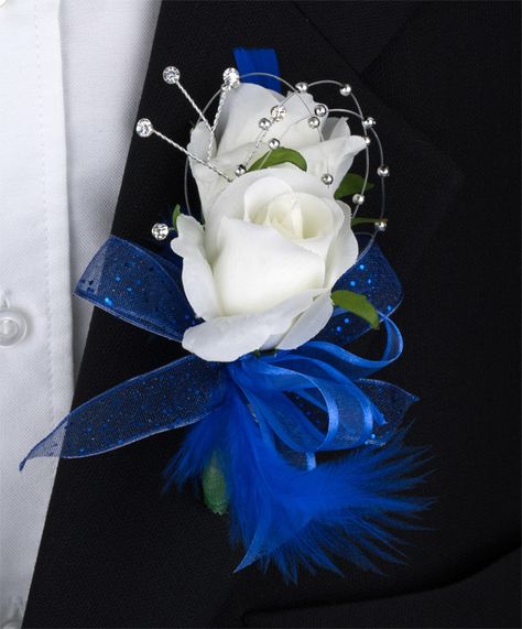 Two white sweetheart roses with feathers, rhinestones and more, shown here in royal blue. Available in fresh or silk flowers. #zeidlersflowers Royal Blue Prom Flowers, Wedding Shower Centerpieces, Prom Things, Prom Flowers Corsage, Blue Boutonniere, Bridal Corsage, Prom Corsage And Boutonniere, Blue Wedding Decorations, Royal Blue Flowers