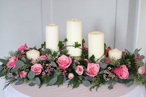 Top table arrangement with roses, spray roses, wax flower, eucalyptus and ivy.  Church pillar candles of different heights.  Liberty Blooms. Table Flowers Arrangements, Wedding Church Decorations, Top Table Arrangement, Top Table Flowers, Flower Eucalyptus, Table Flower Arrangements, Table Arrangements Wedding, Candle Arrangements, Wax Flower