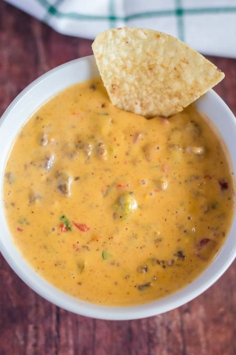 Super easy, super tasty! The BEST hamburger cheese dip that you can make in your crockpot. This recipe is made with ground beef, velveeta, and rotel tomatoes (or salsa) plus a couple other ingredients to take the flavors to the next level. There's so much to love about this recipe… it's easy to make, stays warm in your slow cooker, and is ideal party food for a crowd. You can make a big batch and snack on it while you watch a football or movie. This is the ULTIMATE game day or Superbowl recipe! Hamburger Cheese Dip Crockpot, Cheese Dip Crockpot, Hamburger Cheese Dip, Hamburger Crockpot, Hamburger Cheese Dips, Hamburger Dip, Velveeta Rotel, Warm Dip Recipes, Dip Crockpot