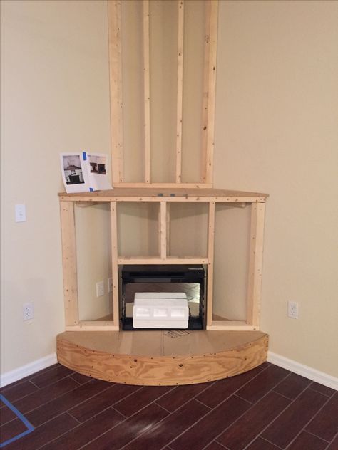 90s Corner Fireplace Makeover, Framing Corner Fireplace, Diy Corner Fireplace How To Build, Diy Corner Fireplace With Tv, Black Corner Fireplace, Pellet Stove Ideas Living Rooms, Wood Burning Stove Ideas, Corner Mantle, Pellet Stove Ideas