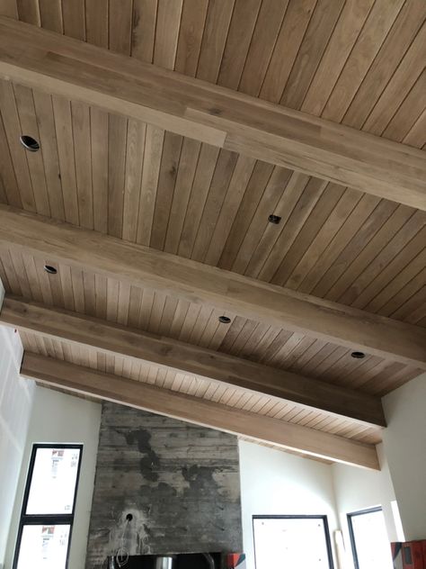 White Oak Tongue and Groove with White Oak beam wraps. Tongue And Groove With Beams, Outdoor Vaulted Wood Ceiling, Interior Beam Stain Colors, Oak Tongue And Groove Ceiling, Tongue And Groove Deck Ceiling, Tongue And Groove Ceiling Dining Room, White Oak Paneled Walls, Vaulted Ceiling Tongue And Groove, Planked Wood Ceiling