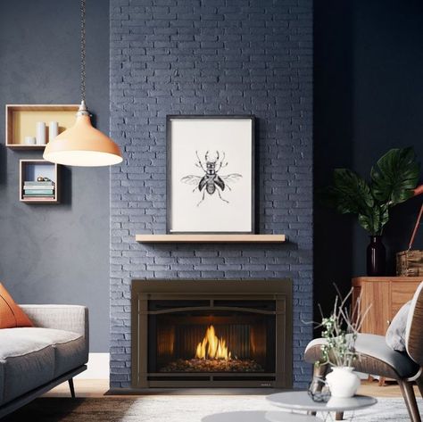 This modern gas fireplace insert with black fluted glass looks gorgeous paired with the navy painted brick fireplace surround. Need a fireplace renovation that works with your modern style? The Heat & Glo Cosmo gas insert can be professional installed in as little as a day. Talk about an easy living room makeover! Painted Brick Fireplace Surround, Easy Living Room Makeover, Brick Fireplace Surround, Modern Gas Fireplace, Fireplace Renovation, Indoor Gas Fireplace, Old Home Renovation, Painted Brick Fireplace, Painted Brick Fireplaces