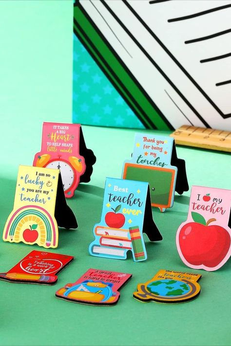 Celebrate your teacher's dedication with the perfect gift! This set of magnet bookmark clips, available in 10 charming styles, ensures you'll always have a reliable marker at hand. They slip into any book without effort. Adorned with delightful Teacher's Day motifs like books, clocks, and apples, they capture the essence of teaching. Suitable for students, professionals, and various settings, these magnetic bookmarks add a touch of practicality to every page-turning moment. Teachers Day Bookmark, Magnets With Cricut, Bookmarks For Teachers, Teacher Magnets, Magnet Bookmark, Teacher Bookmark, Teacher Wallpaper, Message For Teacher, Expo Marker