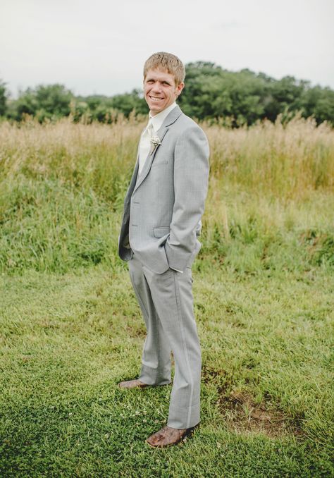 Gray Tux and cowboy boots #barn #rustic #wedding #bessiesbarn #iowa #farming Tux With Cowboy Boots Wedding, Tux With Cowboy Boots, Groomsmen Attire Grey Vest, Grey Vest And Jeans Groomsmen, Groom Attire Rustic Jeans Cowboy Boots, Western Groomsmen Attire Grey, Suit With Cowboy Boots, Tux Prom, Cowboy Groom