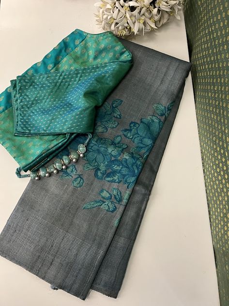 Introducing Veena in a unique and seldom-explored color combination of grey and turquoise. This saree features a threaded border in a matching shade, along with a striped grey blouse piece. For an exceptional and precious ensemble, it is beautifully paired with a pure Kanchipuram silk in turquoise tones, creating a one-of-a-kind look, especially when adorned with our silver stone jewelry. Grey Saree Blouse Combination, Saree Blouse Combination, Saree Color Combinations, Partywear Sarees, Black Dessert, Tussar Saree, Greenish Grey, Blouses Designs, Indian Sari Dress