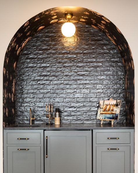 Peep the clever wallpaper placement 👀 —— Built-in bar, arched architecture, wallpaper nook, brick backsplash, modern design, home bar, cabinets. Exposed Brick Bar Area, Arched Built In Bar Cabinet, Bar With Arches Design, Arched Basement Bar, Arched Coffee Nook, Arched Bar Area, Arch Wet Bar, Arched Built In Bar, Dry Bar Built In