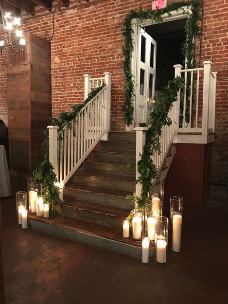 Wolff Ballroom, Washington, Louisiana: wedding reception decor. Pillar candles arranged at bottom of staircase, candle entrance, candle backdrop Candle Entrance, Staircase Candles, Outdoor Wedding Lanterns, Candle Stairs, Candle Backdrop, Wedding Staircase, Candle Alter, Staircase Decor Ideas, Louisiana Wedding