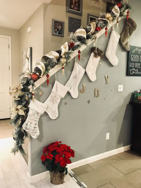 Half Wall Staircase Christmas Decor, Stairs Xmas Decorations, Christmas Stockings On Wall, Christmas Decor Railing Stairways, Wall Stocking Ideas, Staircase Railing Christmas Decor, Stairs Decor Christmas, Xmas Stairs Decorations, Xmas Decor For Stairs