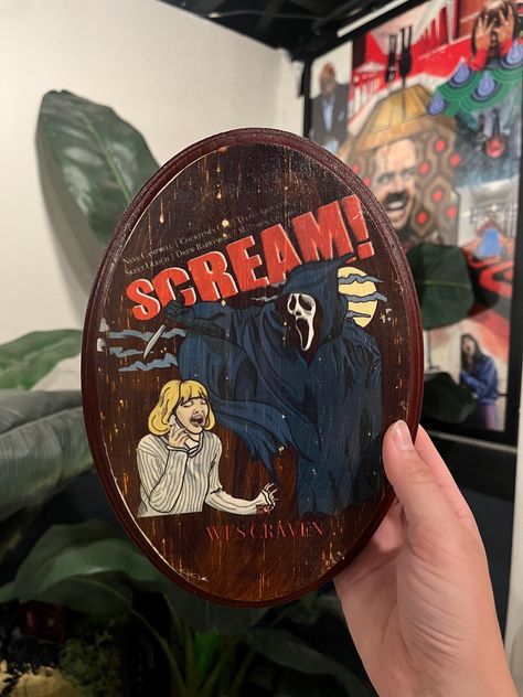 This oval wooden plaque measures 6.75 x 9.75 inches.  The design features "Scream" movie poster artwork. Horror Movies Decor, Horror Movie Room Decor, Horror Themed Room, Creepy Wall Art, Horror Movie Room, Movie Wall Decor, Scream Horror Movie, Scream Movie Poster, Horror Movie Decor