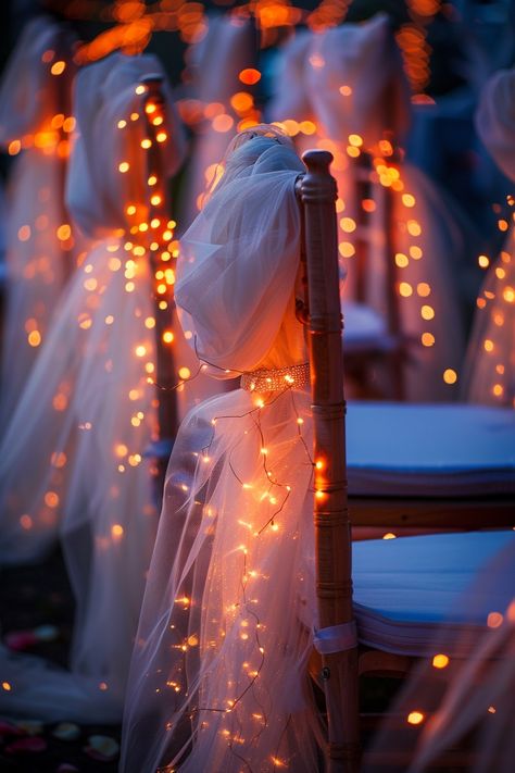 Transform your wedding into a fairytale with these stunning chair decorations. Tulle sashes and fairy lights add an ethereal touch to your reception. ✨🎀💡 Easy DIY setup for a night of wonder. #WeddingInspiration #FairyLights #DIYWedding #WeddingDecor #TulleDecorations #MagicalEvening #BridalStyle #WeddingChairDecor Let the romance sparkle! Tulle And Fairy Lights, Soulmate Wedding, Fairy Light Wedding, Dark Academia Wedding, Roman Wedding, Wedding Chair Decor, Pop Wedding, Tulle Decorations, Simple Elegant Wedding Dress