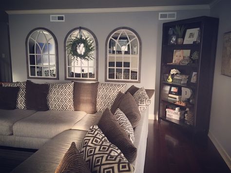 Arched mirrors and succulent wreath. Farmhouse style. I don’t like our couch, but it's huge and we have 65 kids. Arched Couch, Split Level Basement, Arched Mirrors, Above Couch, Basement Plans, Succulent Wreath, Small Remodel, Floor Remodel, Wreath Farmhouse