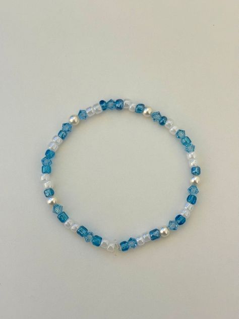 A handmade blue bracelet with freshwater pearls. This bracelet goes with any outfit and is perfect to stack with other bracelets. One size fits all Blue And White Beaded Bracelet, Blue Bracelet Stack, Blue Bracelet Ideas, Pearl Bracelet Ideas, Prom Prep, Light Blue Bracelet, Bead Bracelet Stack, White Dolphin, Dolphin Bracelet