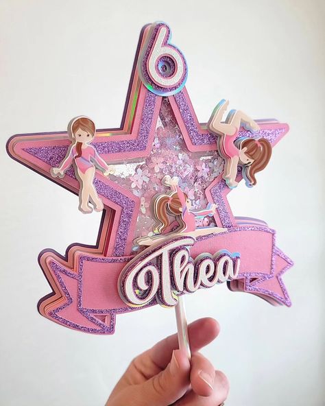 Gymnastic Star Shaker for Thea! #caketopper #shakercaketopper #gymnastics #gymnast #gymnasticlover #tumbling #star #cakedecorating #centerpieces #handmadewithlove #cricutmade #cricutmaker #papercrafter #papercrafts #papercraftersofinstagram #madeinnyc #smallbusiness #smallbusinessmama #mamamade #momsofinstagram #momlife #shopsmall #statenislandsmallbusiness #shoplocal #etsyshop #alternativebabycakes Gymnastics Cake Topper, Gymnastics Cake, Gymnastics Cakes, Gymnast, Baby Cake, Tumbling, Small Shop, Cake Topper, Gymnastics