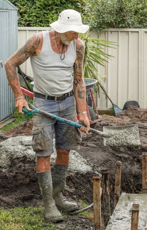 Concreter using shovel to add wet concrete to new floor on residential building site Wet Concrete, Back Pose, Dance Project, Building Site, Art Media, Model Poses Photography, Figure Poses, Figure Drawing Reference, Creative Advertising