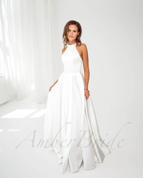 Discover the perfect blend of style and functionality with our modest halter neck satin wedding dress, designed with pockets and a graceful long train. 👰🌟 . . . #HalterNeckDress #SatinWeddingDress #ModestBride #LongTrainDress #WeddingDressInspo #BridalFashion #WeddingGown #ElegantBride #BridalGown #WeddingInspiration #DreamDress #BridalCollection #WeddingStyle #TimelessBeauty #BridalWear #WeddingDayLook #StylishBride #PocketsInDresses #BridalElegance #WeddingMagic #BridalChic #ModernBride #... High Neck Satin Wedding Dress, Simple Ivory Wedding Dress, Simple Wedding Dress Satin, Wedding Dress High Neck, Wedding Dress Halter, Halter Neck Wedding Dress, Wedding Dress Halter Neck, Wedding Dress Satin, Wedding Dress Simple