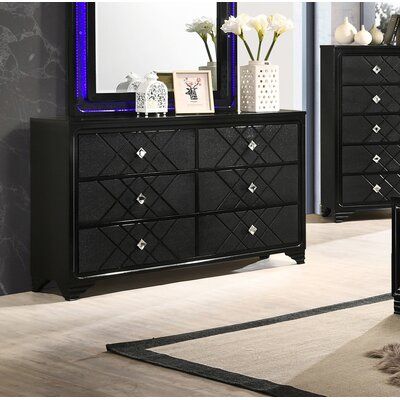 Glitz and glam will overtake your sleeping space with this incredible black dresser. Six drawers display embossed panels with a geometric pattern. The diamond-style acrylic hardware makes for an incredible and elegant upgrade for this contemporary piece. A spacious tabletop brings plenty of space to display decorative items and bedside essentials. Enjoy years of durability and beauty from this piece, crafted from quality Asian hardwood. | Rosdorf Park Marlena 6 Drawer 63" W Double Dresser Wood i Black Dresser Bedroom, Black And Silver Bedroom, Black Bedroom Sets, Acrylic Hardware, Black Bedroom Decor, Silver Bedroom, Black Dresser, Black Dressers, Regal Design