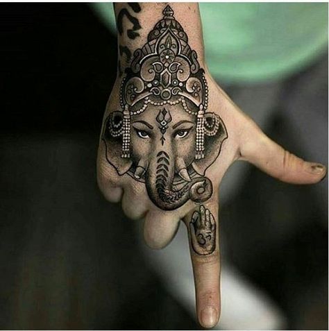 23. Indian lucky charm on the hand This distinctive piece of art on the hand shows an ornate elephant with a traditional Indian sign on its forehead, the icon of a hand on the forefinger is an amusing detail. The tattooing is about a true sense of mindfulness. - source Elephant Tattoo On Hand, Ganesha Tattoos, Indian Elephant Tattoo, Cute Elephant Tattoo, Hindu Tattoos, Tato Tradisional, Ganesh Tattoo, Tato Dengan Makna, Tato Jari