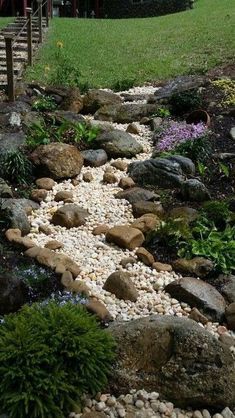 Dry River Bed Landscaping Ideas To Try In 2022 - A Nest With A Yard Funny Vine, Landscaping On A Hill, Dry River, Pathway Landscaping, Rock Garden Design, River Bed, Rock Garden Landscaping, Dry Creek, Rain Garden