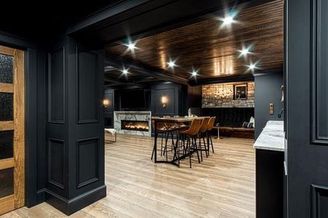 Dark Modern Basement Ideas, Bar Cabinet Next To Couch, Modern Farmhouse Finished Basement, Cabin Style Basement Ideas, Game Room Bar Ideas Basement Designs, Basement Modern Design, Cozy Basement Bar, Basement Lodge Theme, Black Trim Basement