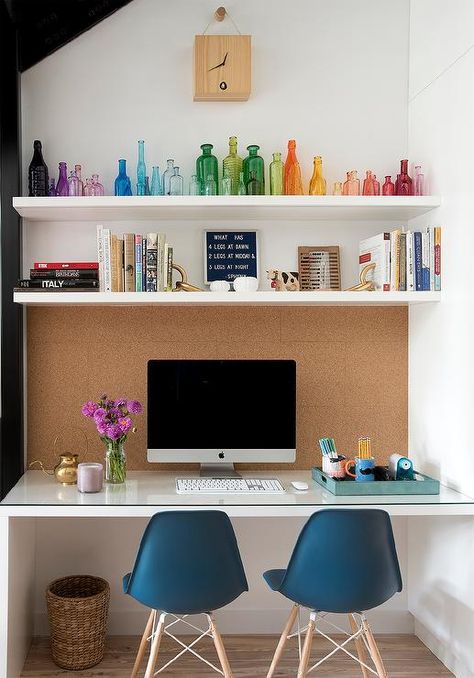 Pinboard over a kid's desk designed with two blue modern chairs and floating shelves styled with colorful accents. Big Desk In Bedroom, Over Desk Shelves, Desk With Shelves Above, Shelf Above Desk, Shelves Above Desk, White Floating Desk, Pinboard Ideas, Desk Nook, Home Nails