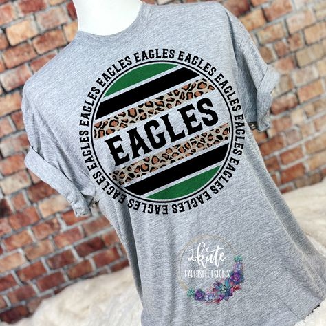 Pick yourself up one of these fun and spirit-filled Eagles spirit shirts. This shirt is sure to impress your friends and make them want one for themselves.  It's a very soft shirt in an athletic heather (gray) color. The shirt is made of 100% polyester but has a cotton feel.  To get the best wear from your shirt make sure to  1. Wash in cold water 2. Tumble dry low 3. Do not iron on design area 4. Do not use fabric softener These shirts say Men's sizes but they are actually unisex sizing. Spirit Wear Designs, School Spirit Shirts Designs, Team Spirit Shirts, Wolverine Shirt, School Shirt Designs, School Spirit Wear, School Spirit Shirts, Cheer Shirts, Leopard Shirt