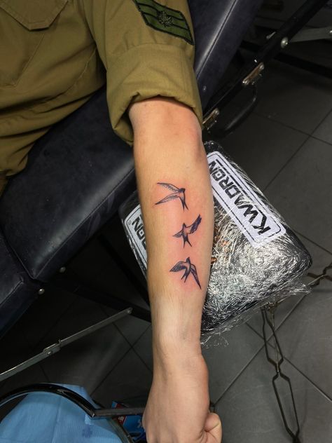 A Tattoo of 3 swallows on a soldiers arm Birds Around Arm Tattoo, Swallows Arm Tattoo, Swallow Hand Tattoo Women, 3 Swallow Bird Tattoo, 3 Birds Tattoo Men, Men Bird Tattoo Arm, Sparrow Tattoo Forearm, Mens Sparrow Tattoo, Small Swallow Tattoo Men