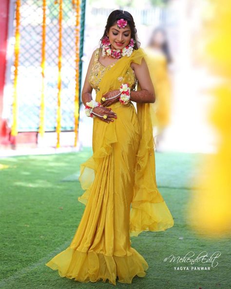 We have curated some head-turning Haldi dresses for you to serve the looks. Take notes & bookmark the ones you love most to own the Haldi ceremony like a queen B! #Haldi #YellowSaree #Saree #rufflesaree Ruffle Saree For Haldi, Pink Saree For Haldi, Yellow Ruffle Saree For Haldi, Haldi Ceremony Outfit For Bride Indian Saree, Haldi Looks For Indian Bride, Yellow Saree For Haldi Bride, Yellow Haldi Outfit For Bride, Haldi Look For Bride In Saree, Haldi Ceremony Outfit Saree