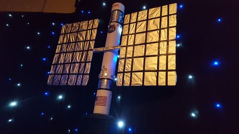 Satellite made from carpet tube, cardboard and foil. Space Station Decorations, Space Vbs Decor, Stellar Vbs Decorations, Vbs Stellar Decorations, Vbs Space Theme Decorations, Nasa Decor, Stellar Vbs 2023 Decorations, Daycare Room Decor, Outer Space Vbs