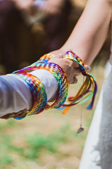 The romantic act of ‘tying the knot’is often used in humanist wedding ceremonies as a symbol of lasting unity.    Photo by Sawyer & Sawyer  #TyingTheKnot #WeddingIdeas #WeddingInspiration #WeddingRituals #GayWedding #SameSexWedding #HumanistWedding #HumanistCeremony #Outdoor Wedding #FestivalWedding #RuralWedding #FarmWedding #CountrysideWedding Wedding Hand Tying Ceremony, Tying The Knot Ceremony, Tie The Knot Ceremony, Hand Tying Ceremony Handfasting, Three Cords Wedding Unity Ceremony God's Knot, Handfasting Ribbons, Humanist Wedding, Humanist Wedding Ceremony, Pride Celebration