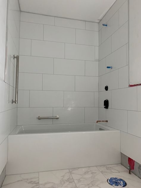 White Tiled Bathtub, Big White Tiles Bathroom Walls, Marble Tile Bathtub, White Glossy Tiles Bathroom, 12x24 Shower Wall Tile With Tub, Large Format Subway Tile Bathroom, 12x24 Bathroom Wall Tile, 8x24 Subway Tile Bathroom, 8x24 Shower Tiles