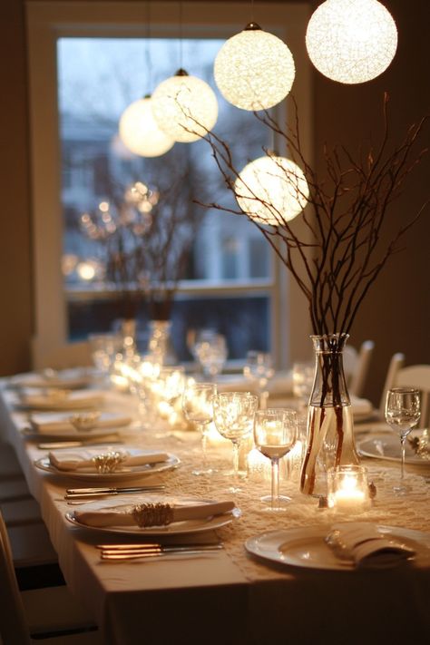 Elegant dining table set with white linen, glowing candles, and hanging spherical lights. Minimalist Table Setting, Dining Table Centerpiece Ideas, Floating Flower Arrangements, Dining Table Centerpieces, Minimalist Centerpiece, Table Centerpiece Ideas, Modern Tablescape, Dining Table Makeover, Creative Centerpieces