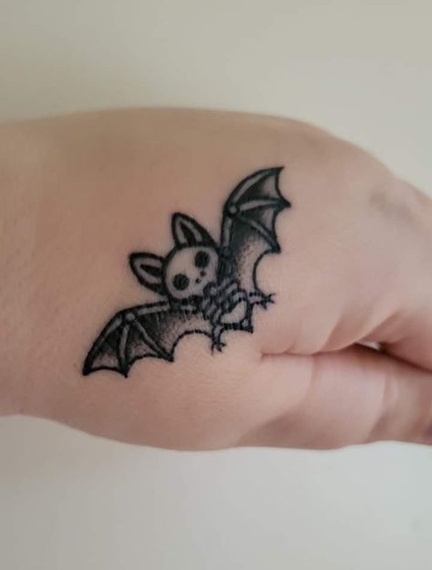 Skull Strawberry Tattoo, Bat Filler Tattoo, Bat Semicolon Tattoo, Simple Spooky Tattoo Ideas, Halloween Tattoo Ideas Small Simple, Halloween Wrist Tattoo, Simple Bat Tattoo Outline, Cartoon Bat Tattoo, Bat Wrist Tattoo