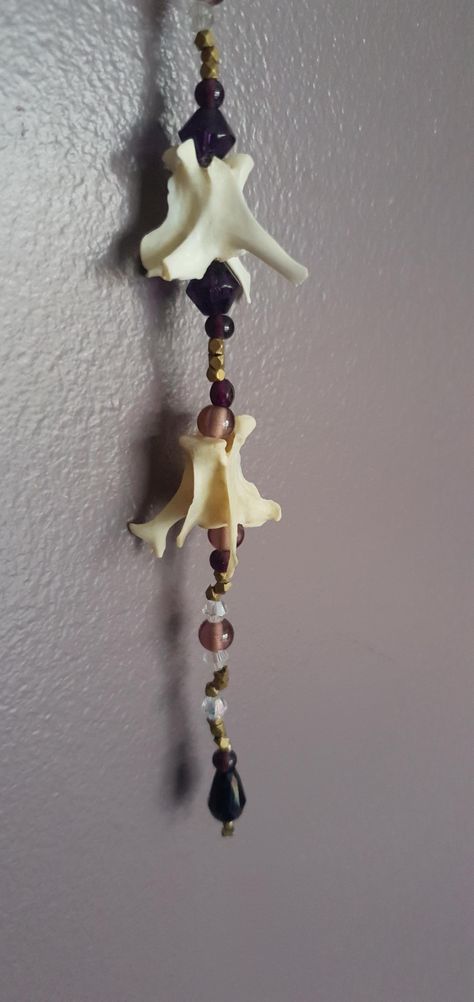 Bone wall hanger/suncatcher made using rabbit bones and a variety of glass/metal beads. All bones are ethically sourced myself through foraging. Bone Wind Chime, Bone Collecting, Bone Decor, Bird Bones, Dark Things, Witch Shop, Bone Crafts, Bone Jewelry, Animal Bones