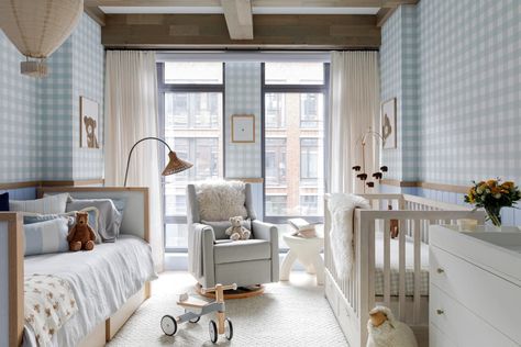 Glider rocker in front of large windows between daybed and crib in nursery with blue and white gingham walls. Nursery With Daybed, Nyc Nursery, Nursery Daybed, Daybed Room, Dreamy Nursery, Changing Table Dresser, Glider Rocker, Playful Decor, Nursery Crib