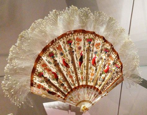 Duvelleroy folding fan, Paris, c. 1900 Painted silk leaf, applied sequins, feather; carved and painted mother- of- pearl monture Vintage Princess Aesthetic, Victorian Accessories, Antique Fans, Fan Decoration, Vintage Evening Bags, Vintage Fans, Vintage Princess, Embroidered Shoes, Folding Fan