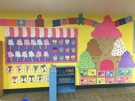 Candyland Theme: bulletin board with Cotton  Candy and cupcakes. Above the bulletin board is a game board with kids game pieces Cotton Candy Bulletin Board, Candyland Bulletin Board Ideas Schools, Candyland Bulletin Board Ideas, Candy Land Theme Bulletin Boards, Cupcake Classroom Theme, Sweet To The Core Bulletin Board, Candy Bulletin Boards, Candy Theme Classroom, Preschool Classroom Themes