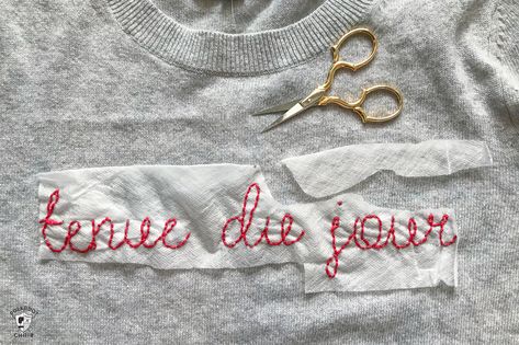 Learn how to make a DIY Embroidered sweater with a fun french quote on it. Includes free embroidery pattern for the quote. A clever way to refashion an old sweater. #DIYEmbroidery #DIYFashion #embroideredsweater #tutorial Embroider A Sweater, Embroidered Sweater Diy, How To Embroider Letters, Sweater With Embroidery, Diy Embroidery Shirt, Easy Sweater Knitting Patterns, Sweater Tutorial, French Quote, Latest Embroidery Designs