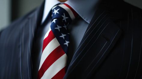 American flag tie, patriotic necktie, business suit, professional attire with flag, flag pattern tie, corporate attire with American flag. 
Suit, patriotic tie, American flag, close-up, stripes and stars, professional clothing, business fashion, navy suit, necktie. American Flag Suit, American Flag Tie, Clothing Business, Patriotic Fashion, Corporate Attire, Flag Pattern, Professional Clothing, Navy Suit, Clothing Men