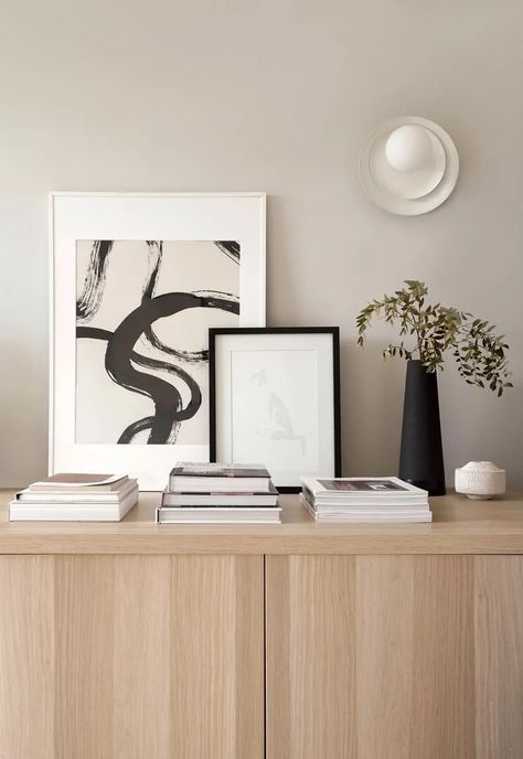 Neutral beige interior with oak sideboard, abstract art and minimalist white wall lamp from sustainable British lighting company Well-lit's 'Clean Conscious' collection | These Four Walls blog Beige Sideboard, Sideboard Styling, Sustainable Lighting, Home Updates, Big Vases, Collage Diy, Beige Interior, Minimalist White, Minimal Wall