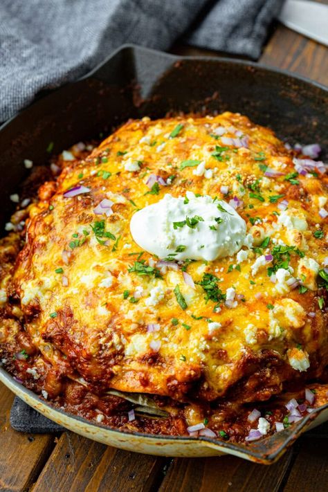 Nothing is better than a skillet piled high with saucy meat, flour tortillas, and gooey cheese. This one-skillet ground beef enchilada casserole is perfect for family dinner! #enchiladacasserole #oneskilletmeal #casserolerecipe Ground Beef Enchilada Casserole, Beef Enchilada Casserole, Skillet Enchiladas, Ground Beef Enchiladas, Beef Enchilada, Enchilada Casserole Recipes, One Skillet Meals, One Skillet, Beef Enchiladas