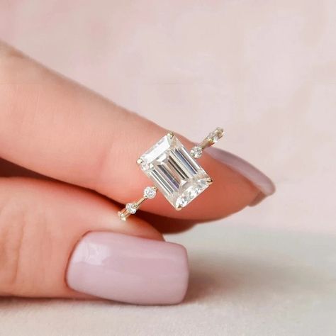 Delicate 1.75 CT Emerald Cut Solitaire/14k Solid Yellow Gold Ring/Wedding Promise Ring/Floating Round Cut Accents/Trends Setter/Gift For Her ❤ ITEM DETAILS:- ✦ Brand: The American Gold House (TAGH) ✦ Handmade, high-quality item! ✦ Material: Solid 10K/14K/18K Gold, 950 Platinum and 925 Sterling Silver ✦ Diamond Type: Moissanite Diamond ✦ Diamond Cut: 8x6 MM Emerald ✦ Diamond Weight: 1.75 CT ✦ Main Stone Color: Colorless ✦ Width of Band: 1.6 MM (Bottom) ✦ Diamond Clarity: VVS/VS ❤ ACCENT/HALO DIAMONDS:- ✦ Side Stone Material: Moissanite Diamond ✦ Side Stone Shape: Round Cut ✦ Side Stone Carat Weight: 0.18 CT ✦ Side Stone Color: Colorless ✦ Diamond Clarity: VVS/VS ------------------------------------------------------------------------------ 💎 Moissanite VS Diamond 💎 ----------------------- Engagement Rings Enerald Cut, Luxury Minimalist Wedding And Engagement Styles, Luxury Minimalist Wedding And Engagement, Sinple Emerald Engagement Ring, Retangle Diamond Ring, Tectangle Engagement Rings, Emerald White Gold Engagement Rings, Simple Elegant Wedding Rings Rectangle, Small Emerald Cut Engagement Ring Simple