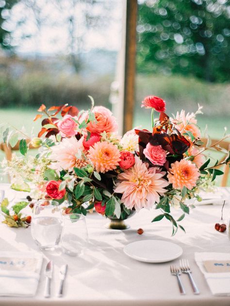 Poppies & Posies arranged this lush, organic fall-inspired centerpiece. Packed with dahlias, ranunculus, roses, and autumn foliage, the arrangement sits pretty at a seasonal reception. Dahlia Centerpiece, Dahlia Wedding, Dahlias Wedding, Unique Wedding Flowers, Fall Wedding Centerpieces, Rustic Wedding Centerpieces, Fall Wedding Flowers, Fall Wedding Decorations, Flower Centerpieces Wedding