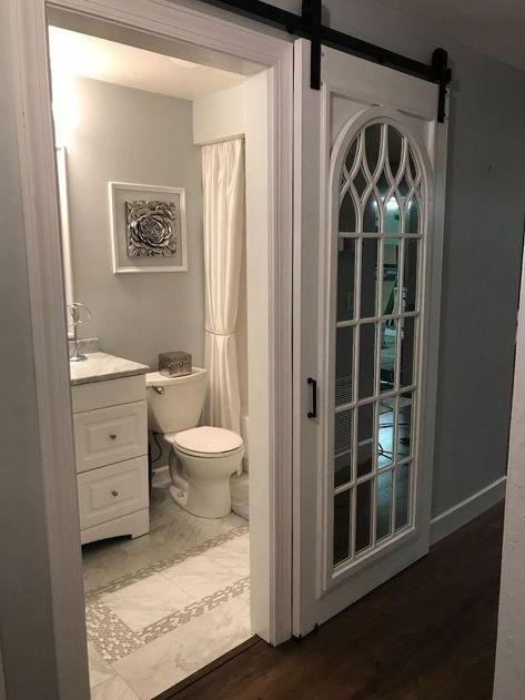 Tiny Hall Bathroom Ideas, Living Room To Bedroom Transition, Door For Bathroom Small Spaces, Unique Bathroom Doors, Small Bathroom With Closet, Unique Small Bathroom, Bathroom Wall Art Ideas, Cathedral Mirror, Mirror Barn Door