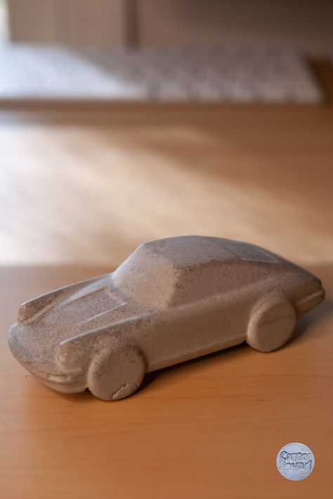 Crafted by hand, our exquisite concrete speedform pays homage to the iconic Porsche designs, evoking a sense of nostalgia and timeless elegance. Minimalistic Sculpture, Clay Cars, Clay Car, Stone Carving Sculpture, Car Sculpture, Automotive Garage, Minimalist Sculpture, Ceramic Car, Sculpture Ceramic