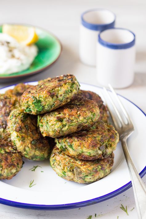 Vegan Greek zucchini fritters are a beautiful mezze dish. Traditionally, they contain eggs and feta, but we've managed to veganise ours to a great effect. Greek Zucchini, Courgette Fritter, Zucchini Fritters Recipe, Lazy Cat Kitchen, Vegan Greek, Cat Kitchen, Vegan Zucchini, Zucchini Fritters, Fritter Recipes