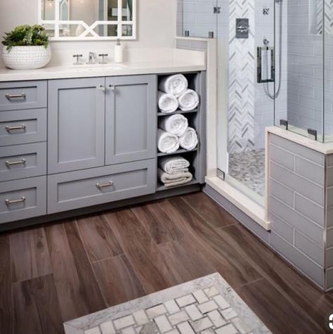 Kids bathroom vanity in grey with wood tile floor, marble tub surround Bathroom Ideas With Dark Wood Floors, Light Grey Vanity Bathroom Ideas, Grey Vanity Wood Floor Bathroom, Gray And Brown Bathroom Ideas, Grey Wood Tile Floor Bathroom, Gray Shower Tile With Wood Floor, Gray Tile Bathroom Floor Wood Vanity, Grey Tile Floor Bathroom Lowe's, Marble Shower Gray Floor