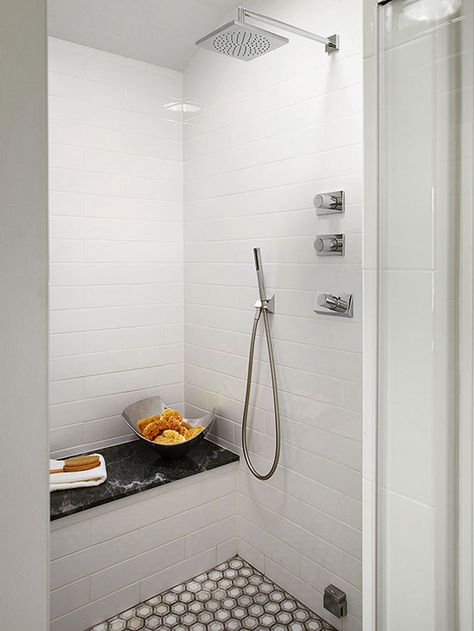 A small shower gets all the bells and whistles with body jets, a rain showerhead, and a handheld wand. Less square footage to eat up a tile budget allows for these luxurious add-ons. Walk In Shower Designs, Shower Controls, Waterfall Shower, Small Showers, Shower Seat, Patterned Floor Tiles, Shower Bench, Shower Seats, White Shower